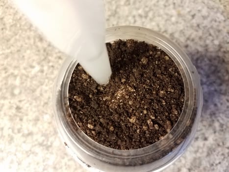 chocolate cookie ice cream in container or cup with straw