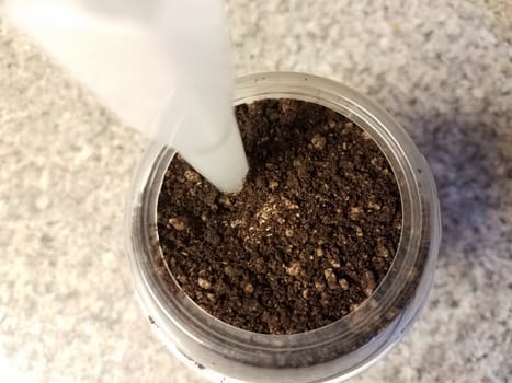 chocolate cookie ice cream in container or cup with straw