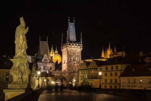 Beautiful night view of the light illuminated Prague Castle and St. Vitus Cathedral in Mala Strana old town by Vltava River from Charles Bridge, Prague, Czech Republic