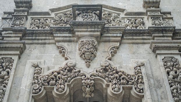 Picture of a sculpted arch over the entrance of a building with byzantine architecture