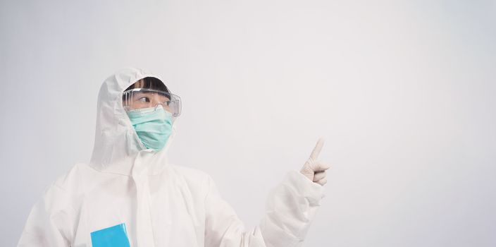 Asia woman doctor in PPE suit or Personal Protective Equipment uniform and wearing medical face mask, rubber gloves and goggles for protect coronavirus pandemic. Studio shot with copy space.