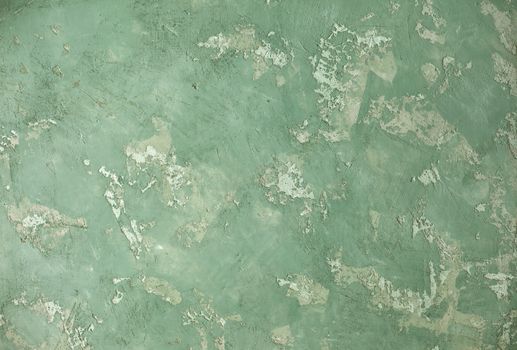 Concrete green khaki background with scuffs and splashes. Textured wall texture in the grunge style with soft focus. Space for text