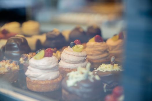 Picture of Chocolate and Cream Muffins and Cupcakes Through the glass of a Window from a bakery