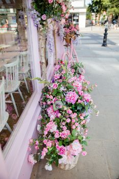 Portrait View of a pink bicycle and Artificial Flowers Outside the Window of a Pink Cake Shop from London, UK