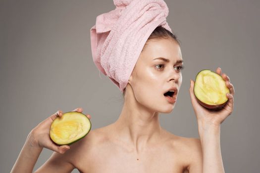 emotional woman with bare shoulders spa treatments clean skin and health mango in hands. High quality photo