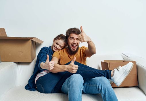 young couple in the room housewarming boxes with things moving emotions fun. High quality photo