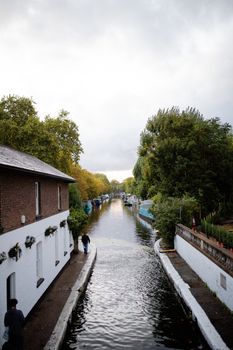 Portrait View of The Cannal of Maida Vale from London, UK Surrounded by Trees and under a cloudy sky