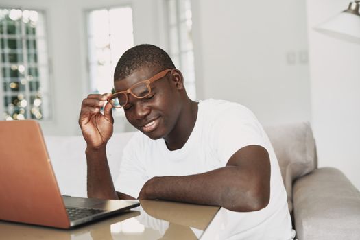 Man at home at the table in front of laptop work office communication