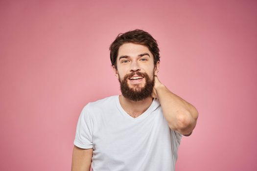 cute bearded men white t-shirt studio pink isolated background. High quality photo