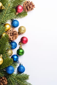 Christmas composition with copy space. Colorful ornament, baubles and fir needles decorations, top view