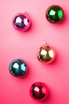 Christmas New Year composition. Gifts, colorful ball decorations on pink background. Winter holidays concept. Flat lay, top view