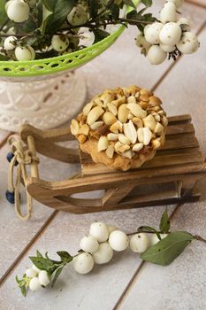 delicious peanut muffins, winter decoration on white wooden table