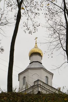 built at the turn of the 19th and 20th centuries in a style reminiscent of classicism, the Orthodox chapel dedicated to Saint Nicholas the Miracle Worker in Logoisk, Belarus. Vertical image