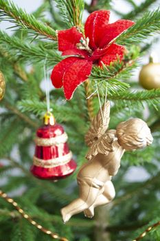 Toy angel hanging on the Christmas tree decoration, vertical image
