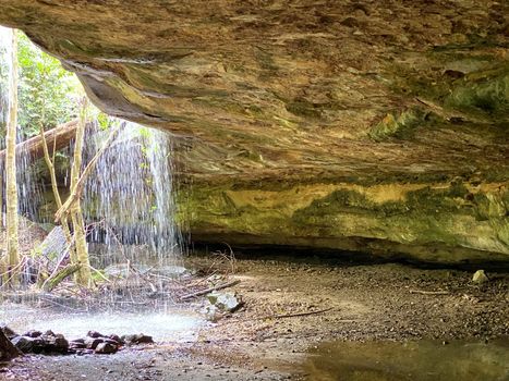 Tranquil cave waterfall after rain