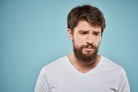 Bearded man emotions white t-shirt lifestyle gestures with hands blue backgrounds. High quality photo
