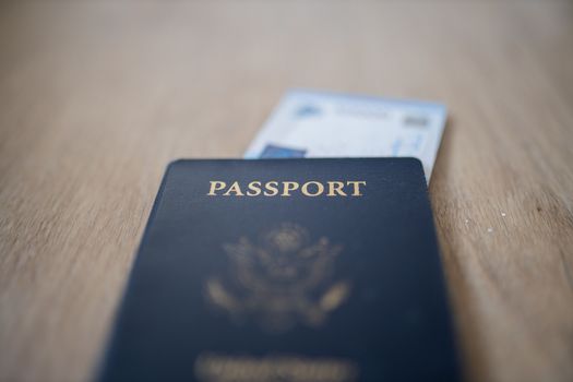 Picture of a United States of America Passport with a Blurry Fifty Thousand Rupees Bill inside