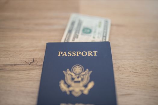 Picture of a United States of America Passport with a Blurry Two-Dollar Bill partially Inside