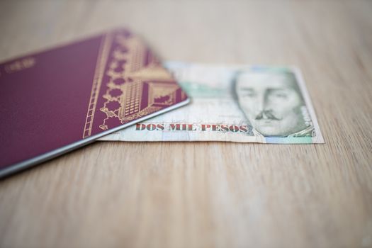 Picture of a Two Thousand Colombian Pesos Bill Partially Inside a Sweden Passport, showing the face of Francisco de Paula Santander