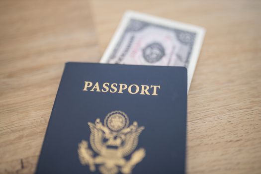 Picture of a United States of America Passport with a blurry Five Ecuadorian Sucres Bill partially Inside