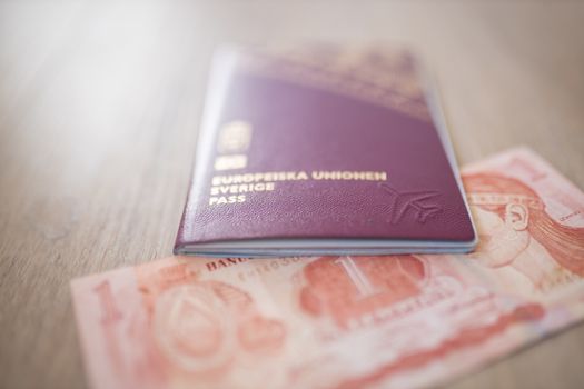 Picture of a Sweden Passport on top of a Blurry Honduran Lempira Bill