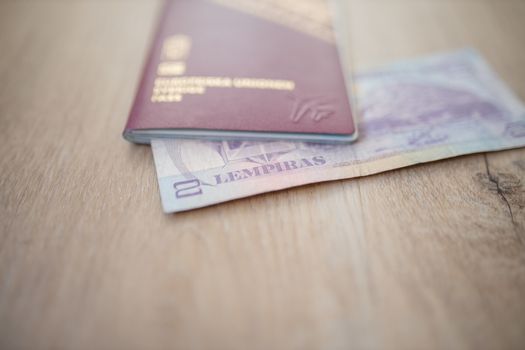 Picture of a Swedish Passport with a Blurry Honduran Lempira Bill partially inside it