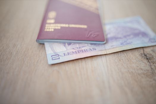 Picture of a Swedish Passport with a Blurry Honduran Lempira Bill partially inside it
