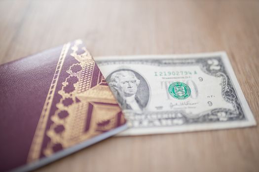Two-Dollar Bill Partially Inside a Blurry Sweden Passport, Showing the face of Thomas Jefferson