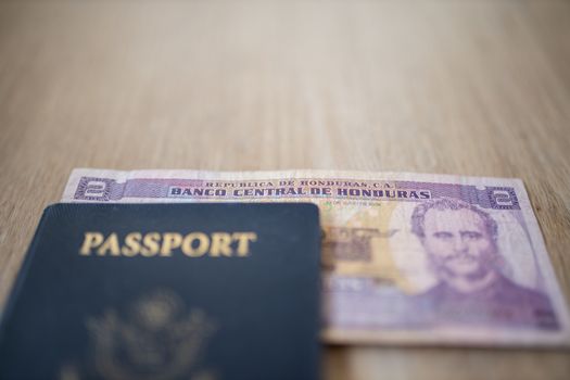 United States of America Passport with a Two Honduran Lempiras Bill partially under it, showing the face of Marco Aurelio Soto