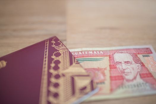 Picture of a Sweden Passport with a Ten Guatemalan Quetzales Bill partially Inside, showing the face of Miguel Garcia Granados