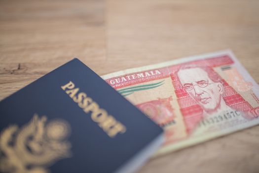Picture of a United States of America Passport with a Ten Guatemalan Quetzales Bill partially Inside, showing the face of Miguel Garcia Granados