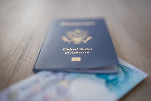 United States of America Passport with a Blurry Five Pound note inside