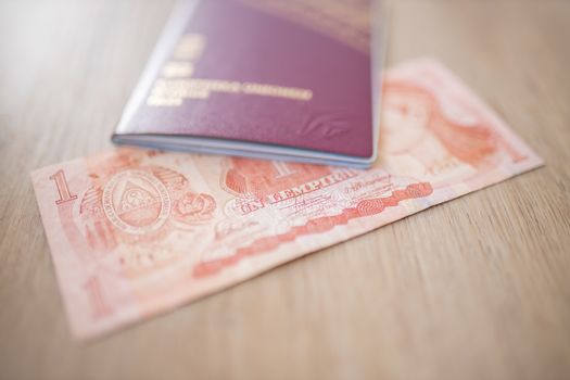 Picture of a Swedish Passport on top of a Blurry Honduran Lempira Bill