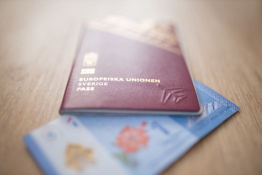European Union Sweden Passport covering part of a blurry One Malaysian Ringgit Note