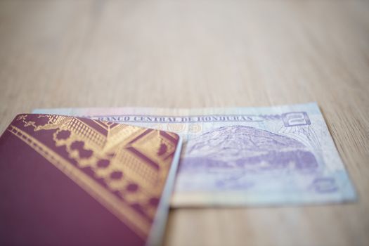 Picture of a Swedish Passport with a Two Honduran Lempiras Bill partially inside it