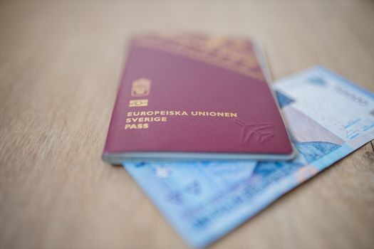 Picture of a Fifty Thousand Indonesian Rupees Bill partially inside a Sweden Passport