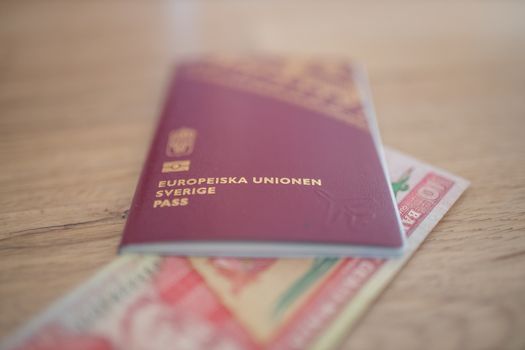 Picture of a Sweden Passport with a Blurry Ten Guatemalan Quetzales Bill Inside