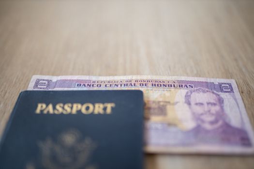 United States of America Passport with a Two Honduran Lempiras Bill partially under it, showing the face of Marco Aurelio Soto