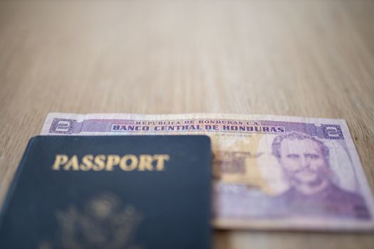 United States of America Passport with a Two Honduran Lempiras Bill partially under it, showing the face of Marco Aurelio Soto