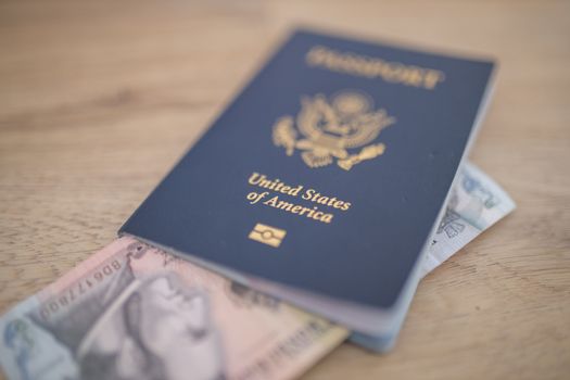 United States of America Passport with a Five Honduran Lempiras Bill Partially Inside, showing the Face of Francisco Morazan