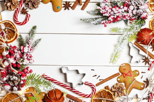 Christmas flat lay background with traditional gingerbread cookies dried orange cinnamon on wood , copy space for text