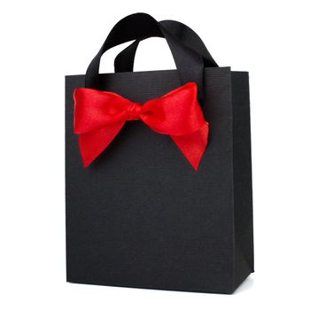 Black Friday paper bag with red ribbon bow isolated on white background sale concept