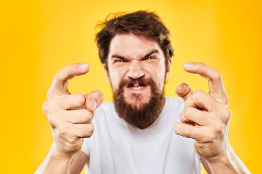 bearded man gesturing with hands studio lifestyle discontent yellow background. High quality photo