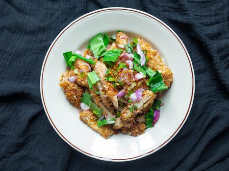 Thai food Spicy Chicken Salad is a favorite of locals in Thailand. You can find it in the street food stalls. Using fried chicken as a staple