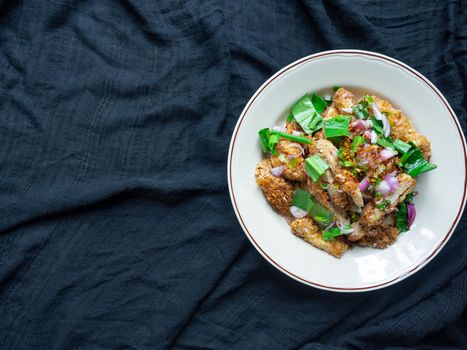 Thai food Spicy Chicken Salad is a favorite of locals in Thailand. You can find it in the street food stalls. Using fried chicken as a staple