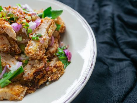 Thai food Spicy Chicken Salad is a favorite of locals in Thailand. You can find it in the street food stalls. Using fried chicken as a staple