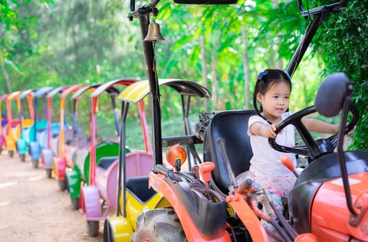 little girl playing to drive a train