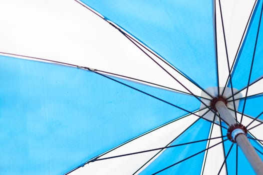 angle view of blue umbrella under sunshine, summer season