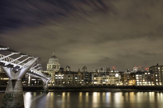 Landscape of Saint Paul Cathedral and other Buildings at Nighttime with the city lights reflecting on the River Thames