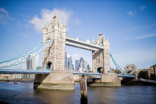 Landscape View of the Tower Bridge -inaugurated in 1894- over the River Thames, under a blue sky and with a Cityscape as background